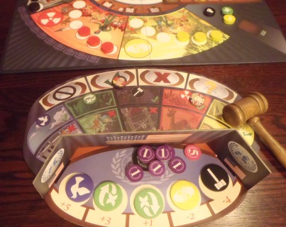 One player's mat with a bit of the central board beyond. There are two bribes in front of the player's shield.